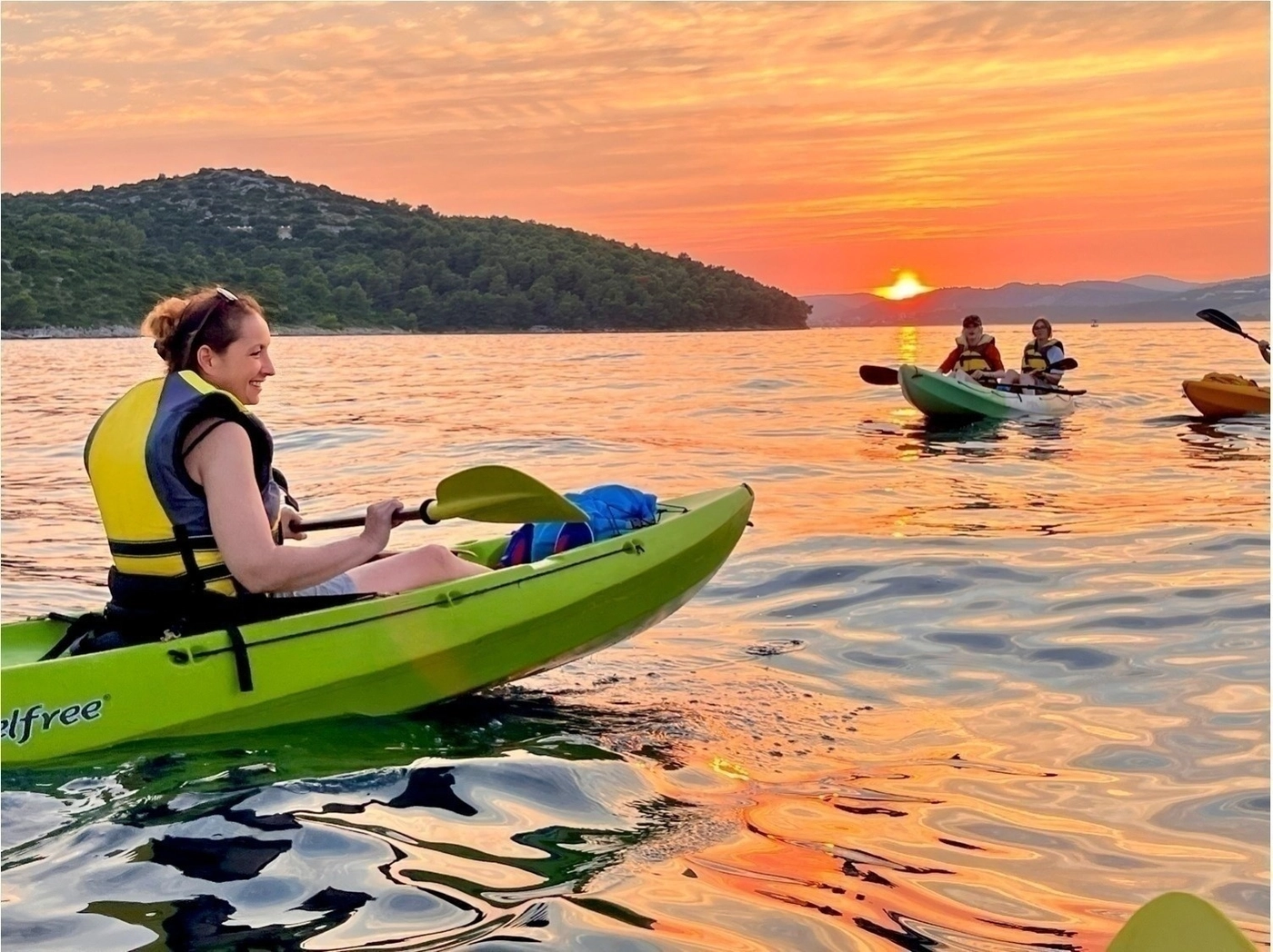 Hidden Adriatic bay with kayaks on the pebble shore